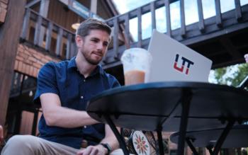 man studying on laptop outdoors