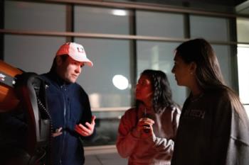 students with telescope during night