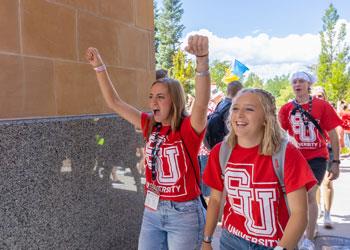 students cheering in red SU shirts