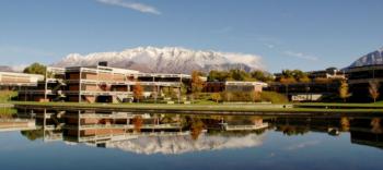 campus buildings with mountain reflection on water