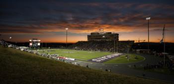 stadium lights at dusk with field in view